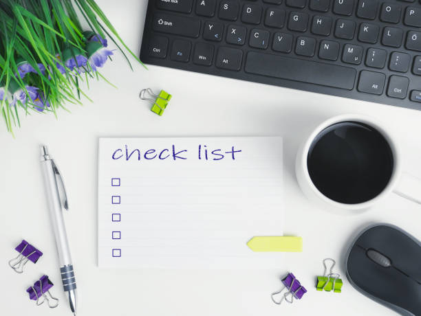 Printed ergonomics checklist on desk with pen